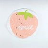 A reusable fruit shower cap shaped like a strawberry with a green leaf and the word smile on it.