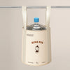 A beige foldable aluminum foot bath bucket hanging from a bar, with a blue cap visible.
