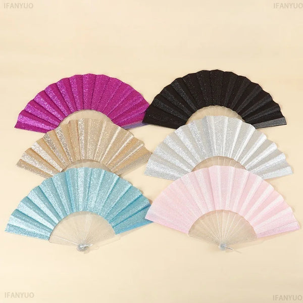 A collection of five folding hand fans in various colors including pink purple black silver and light blue