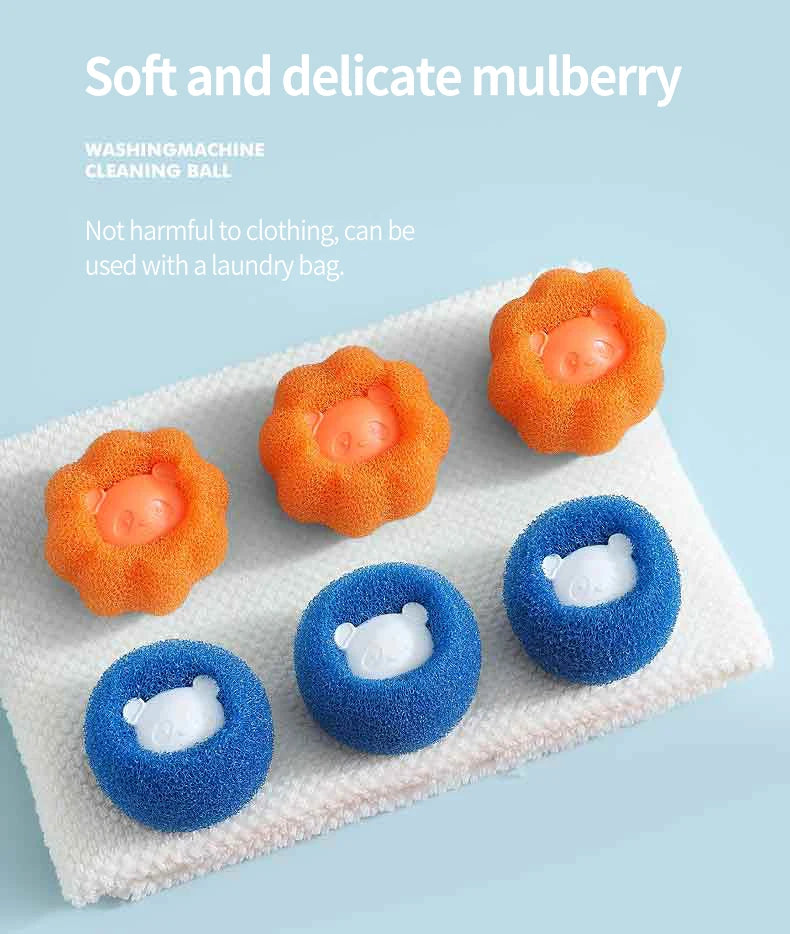 Several soft and delicate mulberry cleaning balls in orange, blue, and yellow are displayed on a white towel.