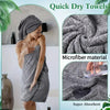 A woman is using a gray microfiber quick dry towel, highlighting its absorbency and softness.