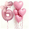 Un set de seis globos de aluminio en forma de corazón rosa que forman el número 6, atados con cintas rosas.