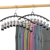 Estante secador de perchas de acero inoxidable con organizador de múltiples clips sosteniendo varias camisas de colores en un