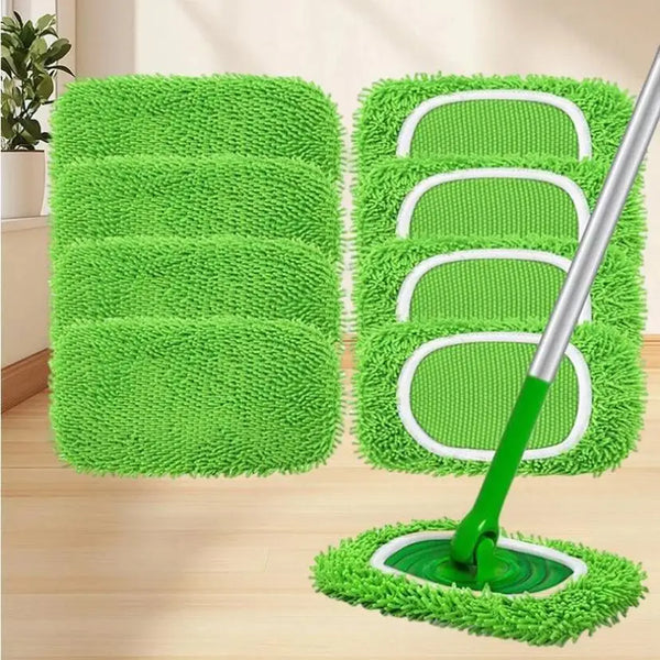 A set of four reusable green microfiber mop replacement cloths and a green mop head on a wooden floor.