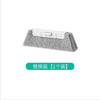 A gray window and gap cleaning brush with a white handle.