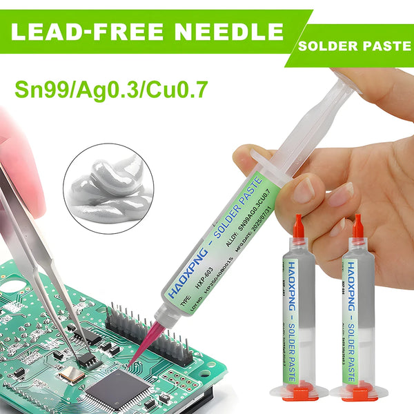 A syringe filled with lead-free solder paste is shown next to a green circuit board and a soldering iron tip.