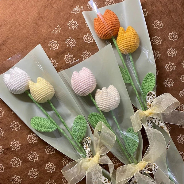A bouquet of handmade cotton carnation flowers in orange and yellow colors tied with sheer ribbon.