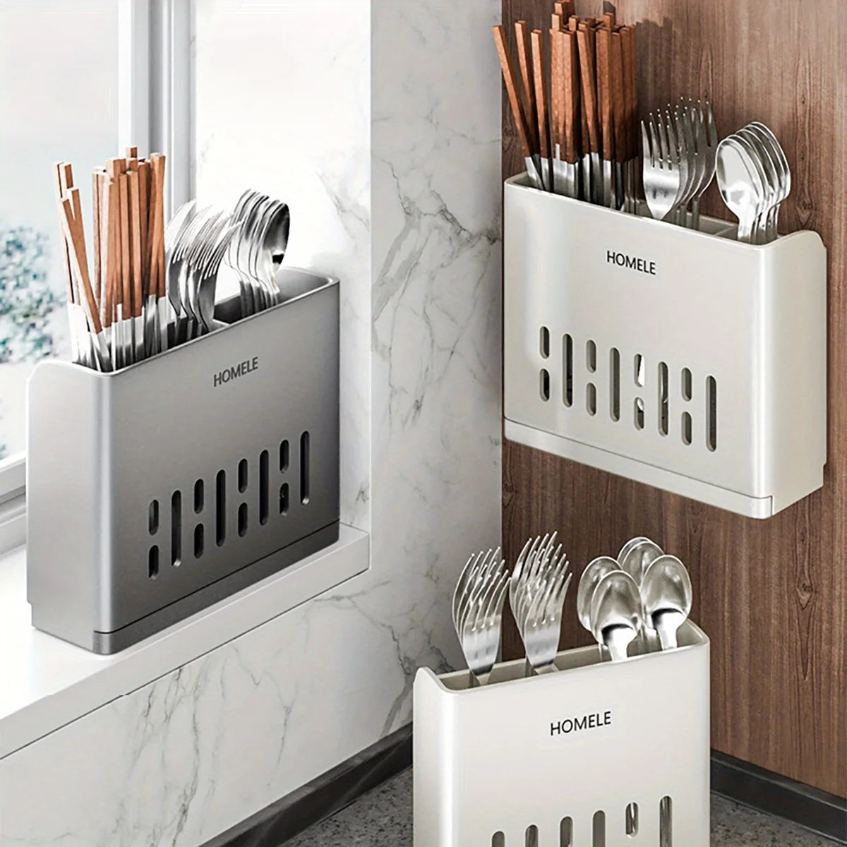 A set of stainless steel cutlery stored in a modern, rectangular white storage rack on a kitchen counter.