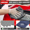 A hand wearing a glove is cleaning a red car surface with a gray microfiber cloth, demonstrating zero edges and scratches.