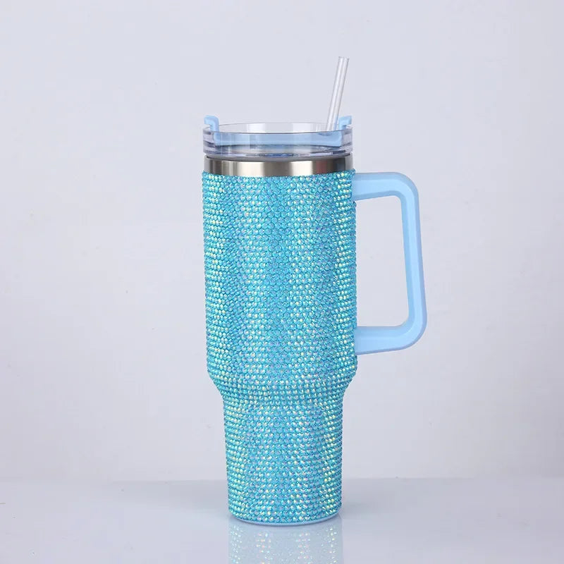 Un termo aislado de cristal brillante azul con tapa transparente y pajita, visto de lado.