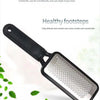 A black professional foot file and callus remover tool with a silver textured surface is shown against a white background.