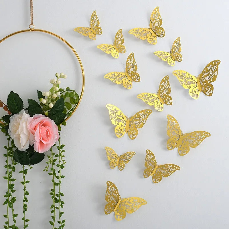 Gold glitter butterfly wall stickers hanging from a gold hoop with green foliage