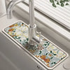 A modern kitchen faucet with a decorative mat featuring floral patterns and natural earth tones.