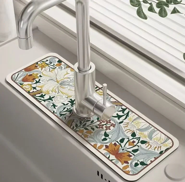 A modern kitchen faucet with a decorative mat featuring floral patterns and natural earth tones.