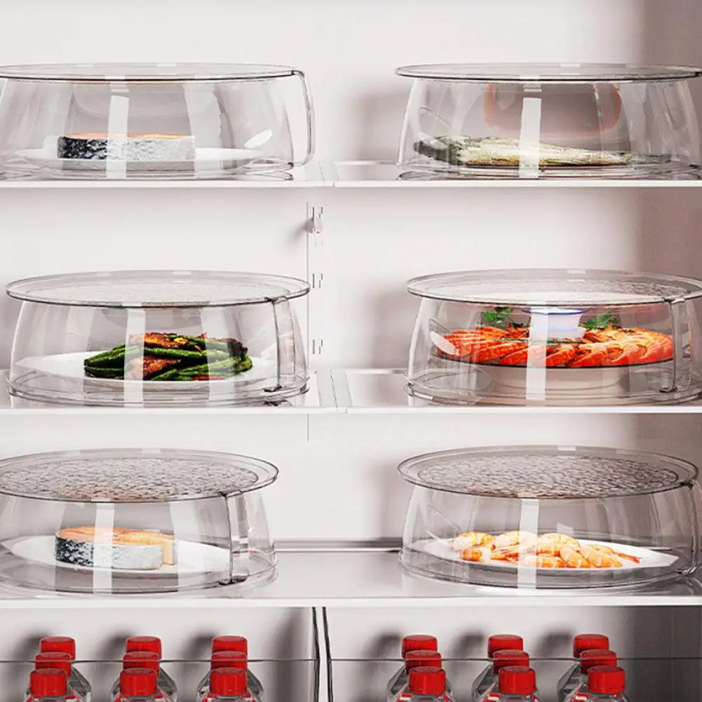 A display of clear microwave splatter guards with heat-resistant handles, holding various food items on a white shelf.
