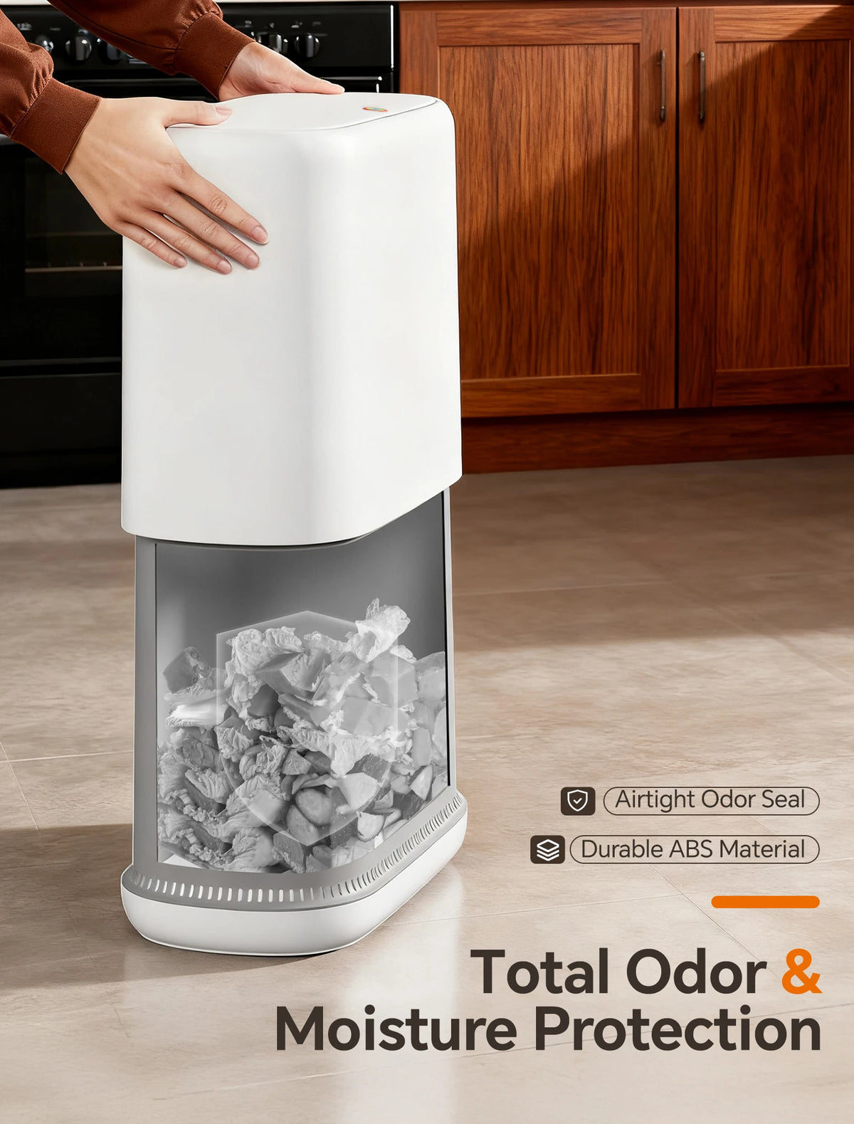A white slim hands-free trash can with a clear lid is shown next to wooden cabinets.