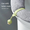 A silicone toilet lid lifter is shown attached to a toilet, demonstrating its adjustable width feature.