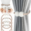 Set of pearl magnetic curtain tiebacks, white and beige, on a gray curtain.