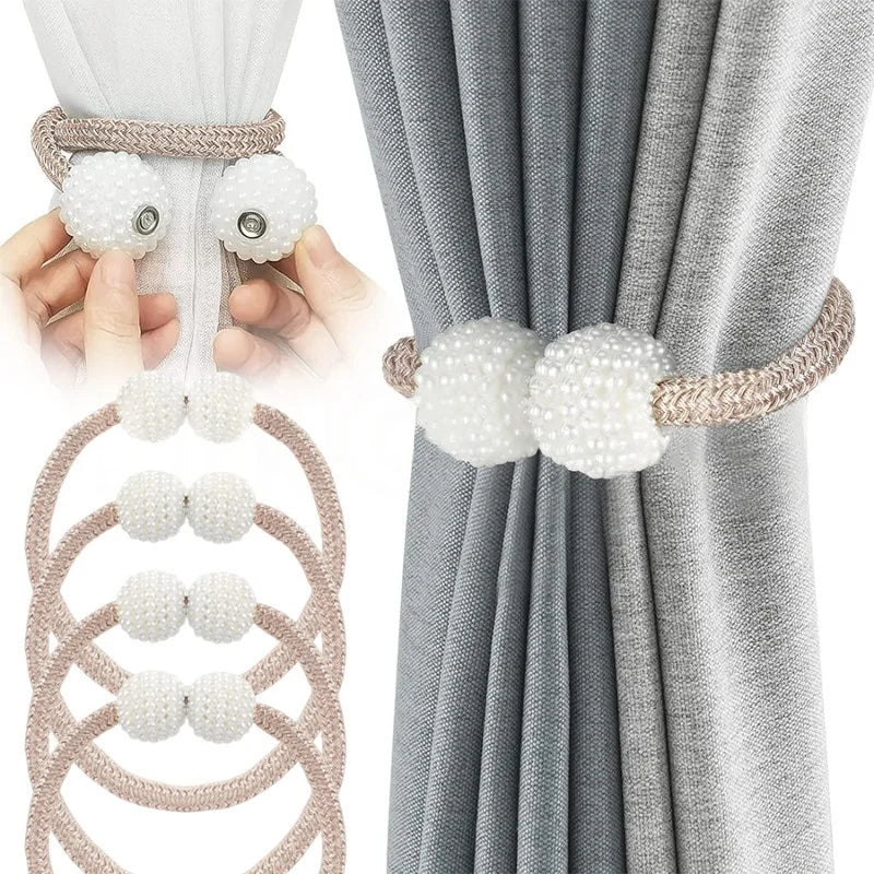 Set of pearl magnetic curtain tiebacks, white and beige, on a gray curtain.