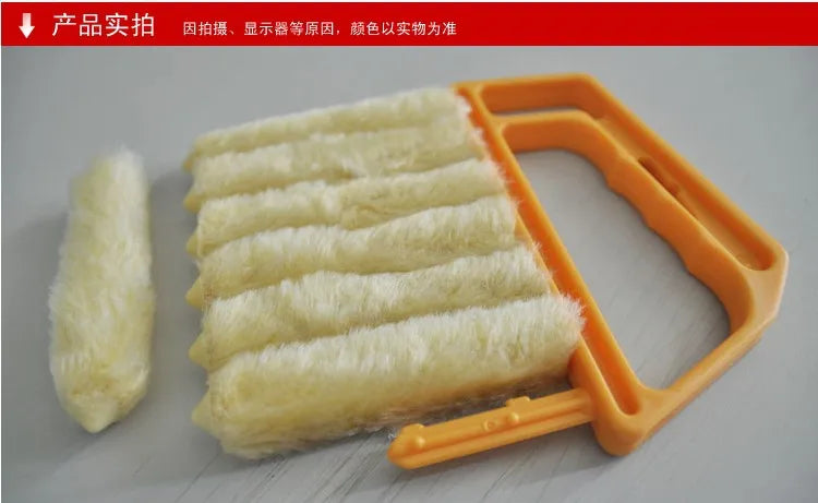 A close-up view of a yellow multi-functional cleaning brush with several white bristles, used for cleaning blinds and crevice