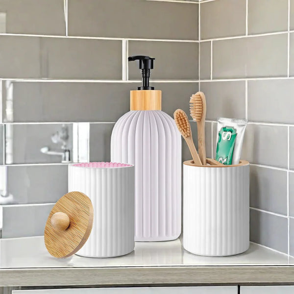 A set of white and wood apothecary style bathroom organizers including a pump dispenser and toothbrushes on a shelf.