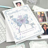 A white photo album featuring a butterfly design and text on the cover, surrounded by other photo pages.