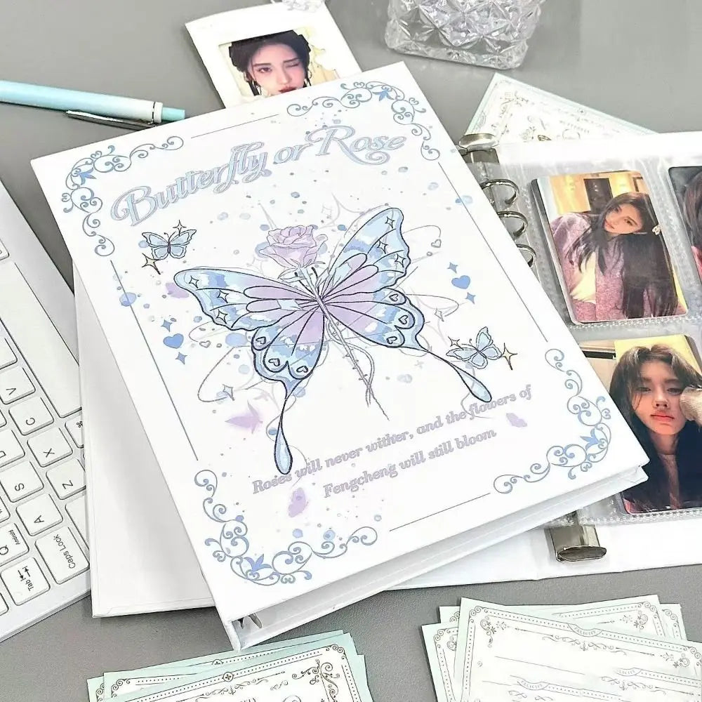 A white photo album featuring a butterfly design and text on the cover, surrounded by other photo pages.