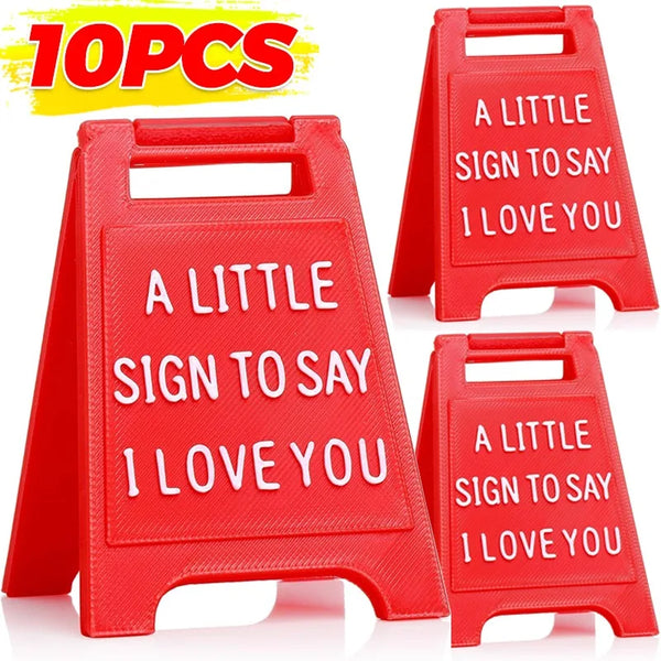 Ten red plastic signs shaped like a chalkboard saying I love you