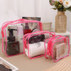 A set of three clear pink travel makeup organizer bags containing various cosmetic products.