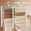 A silver multi-layer pants hanger with non-slip clips is shown holding folded fabric garments.