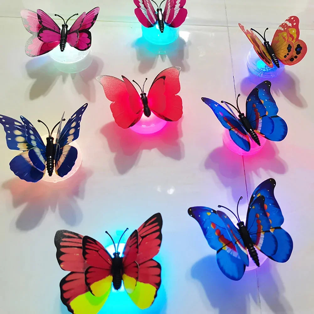 A display of luminous 3D butterfly wall lights in various colors including pink, purple, blue, and orange.