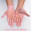 A pair of pink nitrile cleaning gloves are shown on a hand, demonstrating they are free from oil stains.