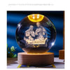 An illuminated crystal ball set featuring a depiction of Jesus and Mary for spiritual devotion.