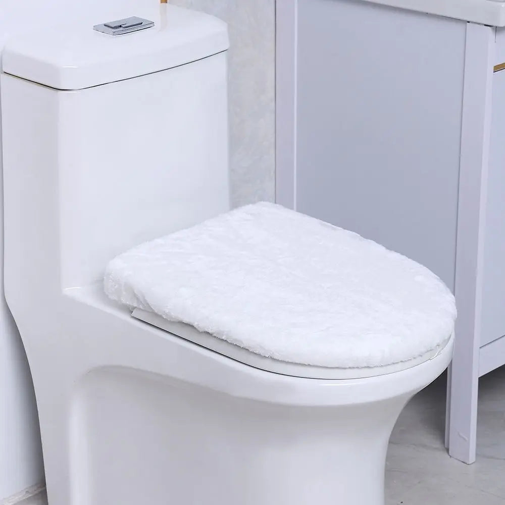 A white protective toilet seat cover is placed on a white porcelain toilet bowl.