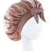 A silky satin sleep bonnet in a dusty rose color tied with a bow, displayed on a white mannequin.