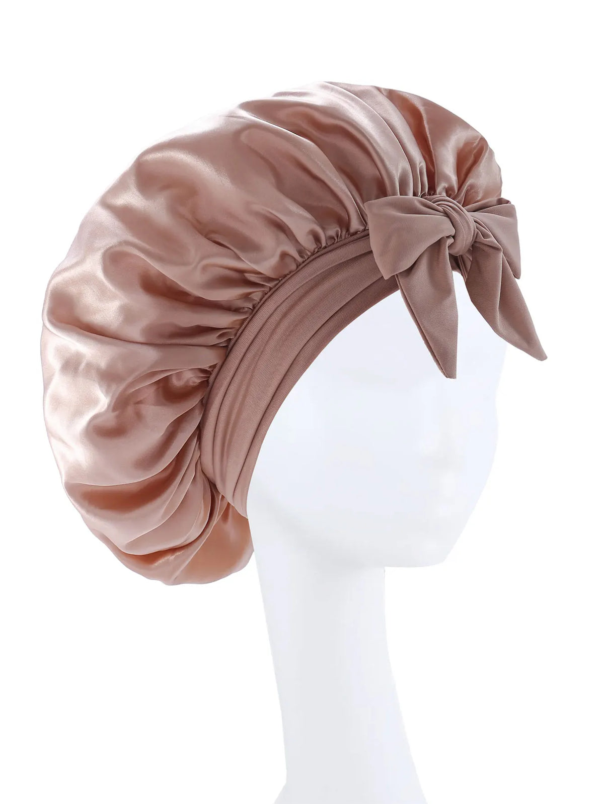 A silky satin sleep bonnet in a dusty rose color tied with a bow, displayed on a white mannequin.