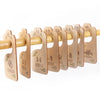 A set of wooden baby closet dividers with age labels ranging from newborn to toddler.