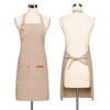 A beige canvas apron displayed on a mannequin, featuring adjustable straps and a front pocket.