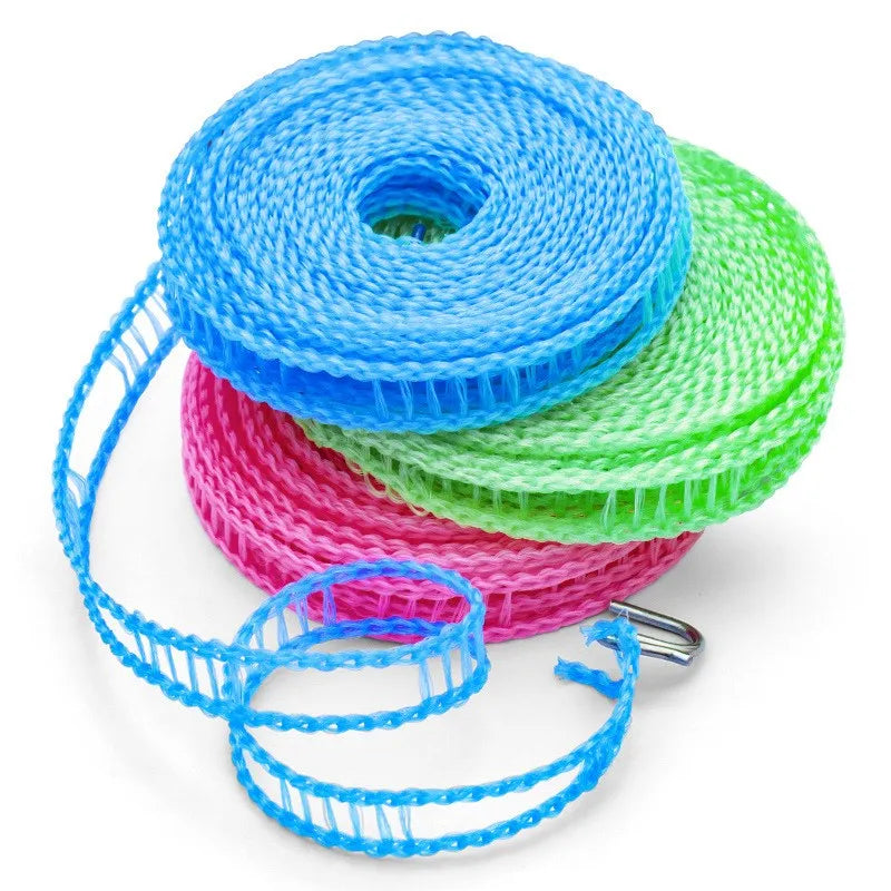 A spool of blue, green, and pink portable windproof clothes drying line string.