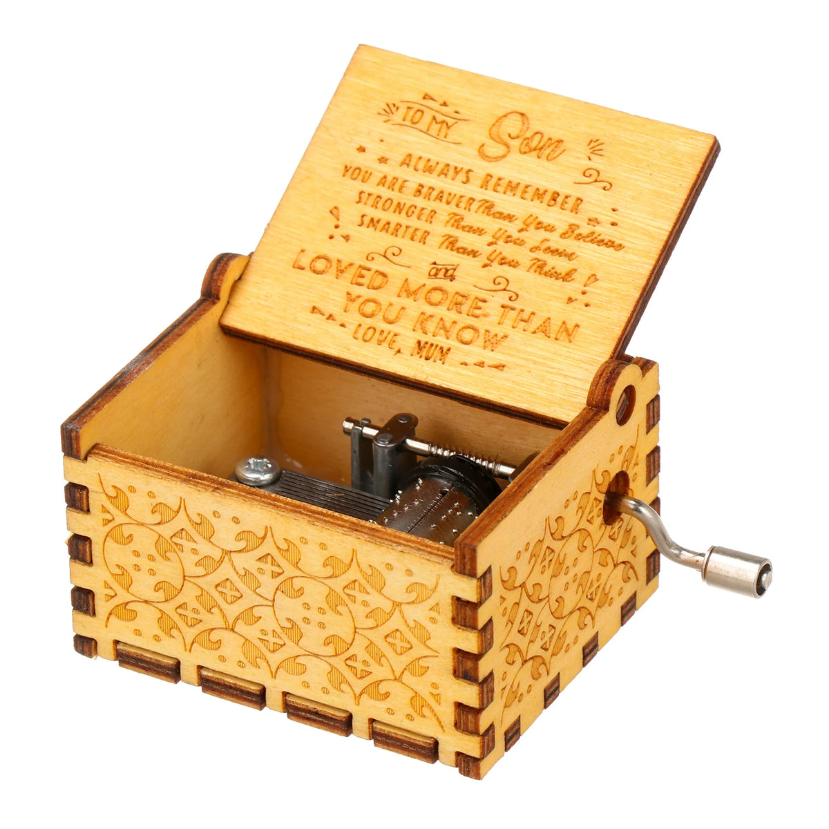 A vintage engraved wooden music box with a lid open showing an inscription on the inside