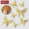 48 pieces of gold glitter butterfly wall stickers displayed next to a slice of lemon and an egg.