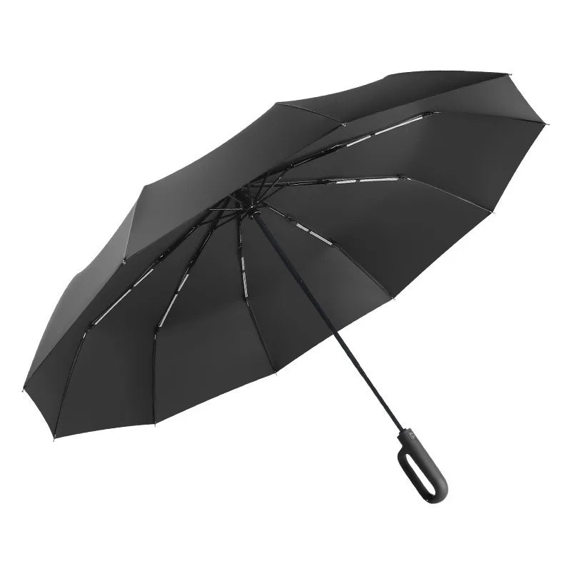 A black windproof automatic folding umbrella viewed from above.