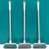 Three long-handle floor scrub brushes with silver and pink handles and grey bristles against a teal background.