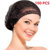 A woman is modeling a black disposable bouffant hair net cover on her head.