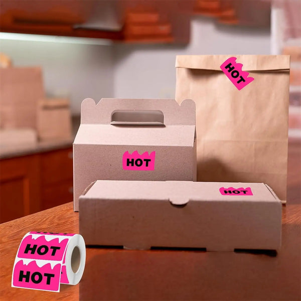 Several brown cardboard boxes and paper bags are visible, marked with fluorescent pink HOT stickers.