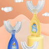 A yellow baby U-shaped silicone toothbrush with a blue penguin design and a blue toothbrush, displayed on a pink stand.