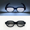 A pair of black LED light up anime glasses viewed from the front against a dark background.