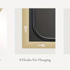 A full length arch mirror with an aluminum frame showing its depth, hanging hooks, and included hardware.