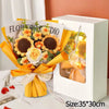 A handmade crochet flower bouquet wrapped in yellow paper displayed inside a white box.