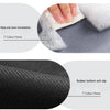 Close-up of a black anti-slip floor mat showing its texture and features like immediate cleaning and rubber bottom.